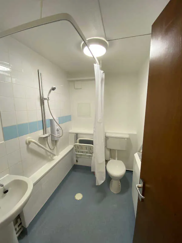 Accessible wet room with shower, grab rails and bathroom fittings