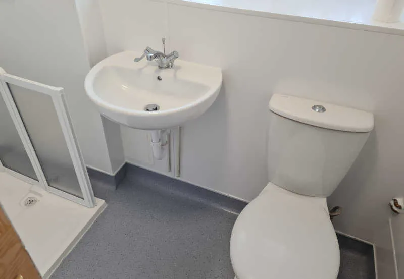 Completed accessible wet room with shower and bathroom fittings